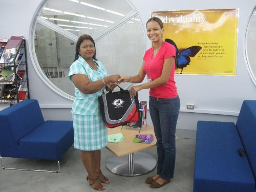 Sharon Beharry presents Lanyve Albert with her SBCS token